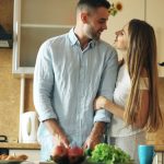 Portrait of loving couple cooking breakfast smiling in the kitchen at home